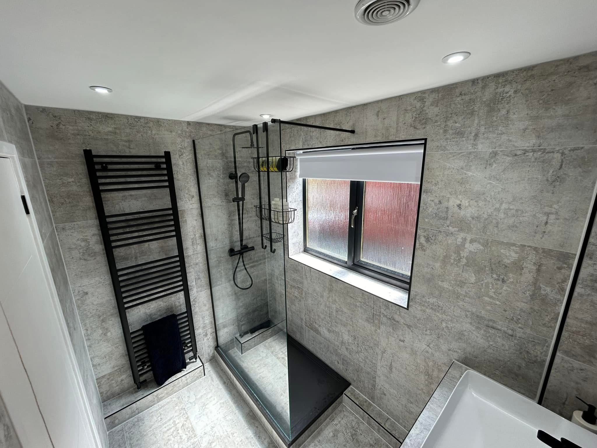 Grey stone tiled bathroom with walk-in shower