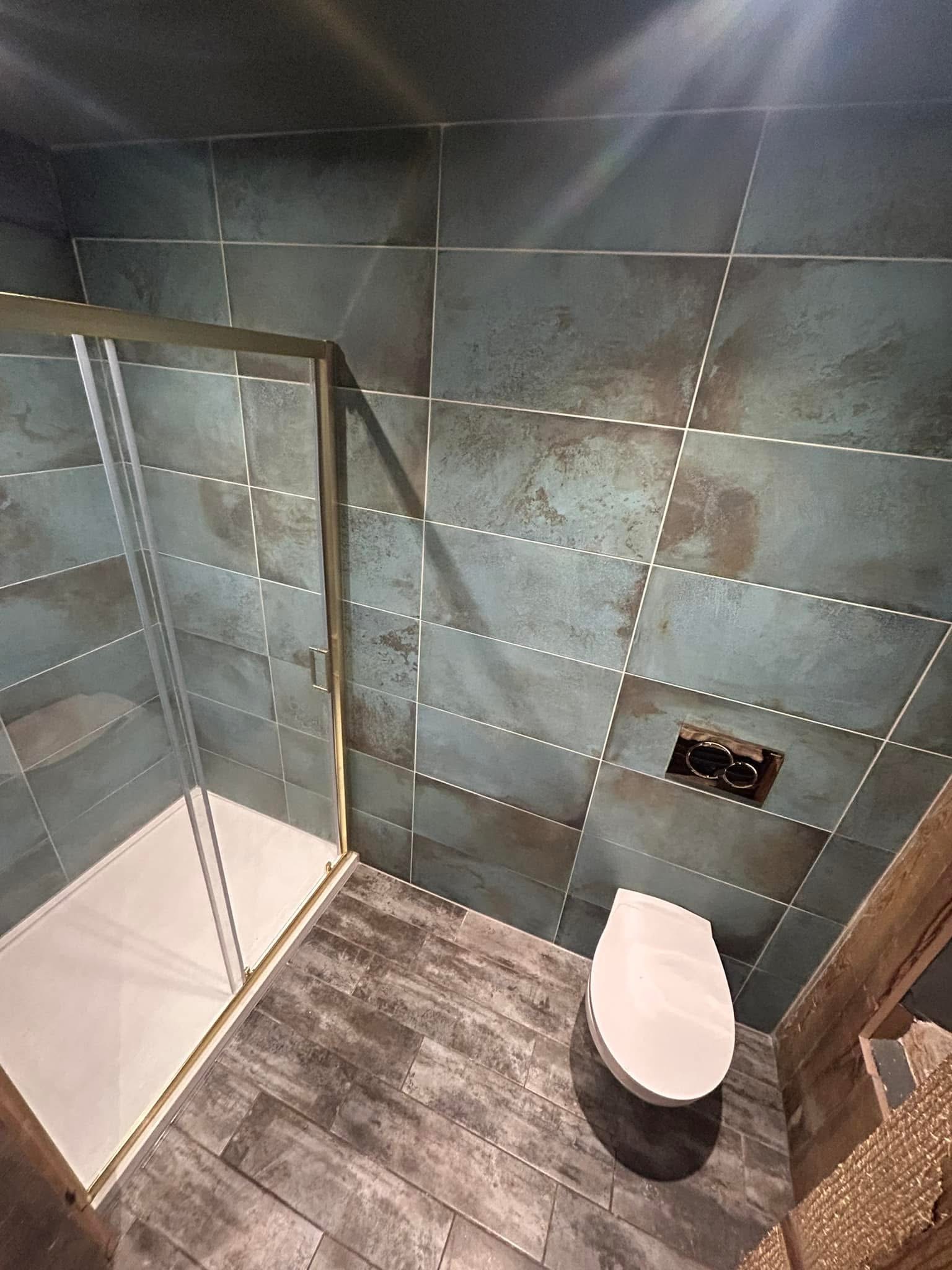 Modern shower bathroom with teal tiled walls