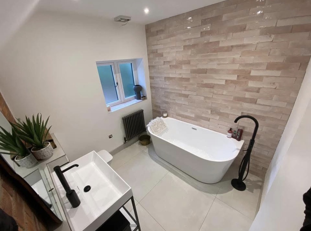 Modern bathroom with freestanding tub and stone tiles